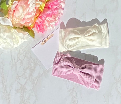 White and purple headbands with bows